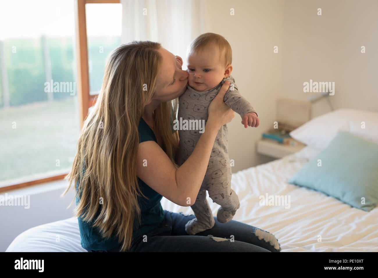Mother kissing her baby boy Stock Photo