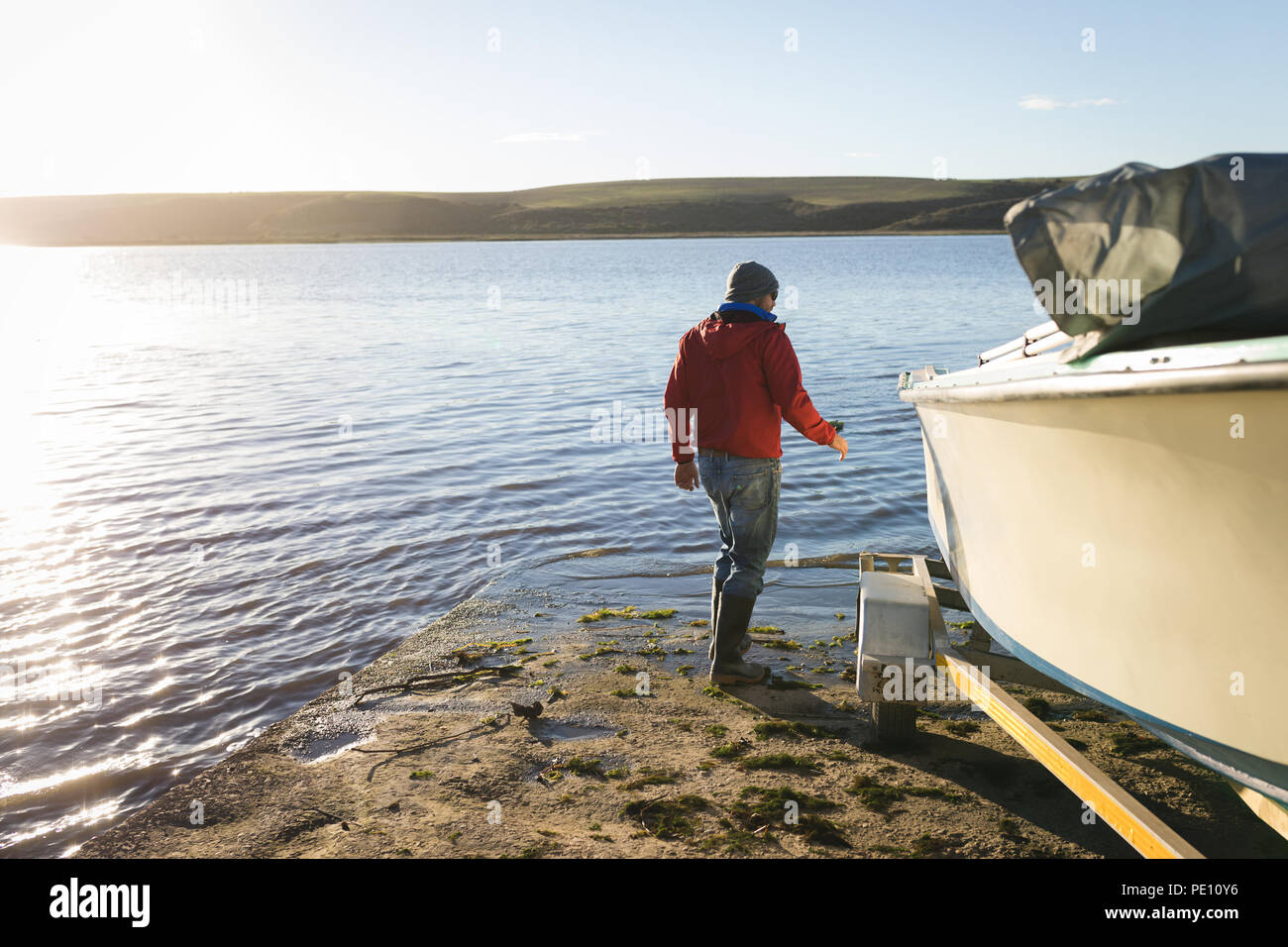 Man checking motorboat Stock Photo - Alamy