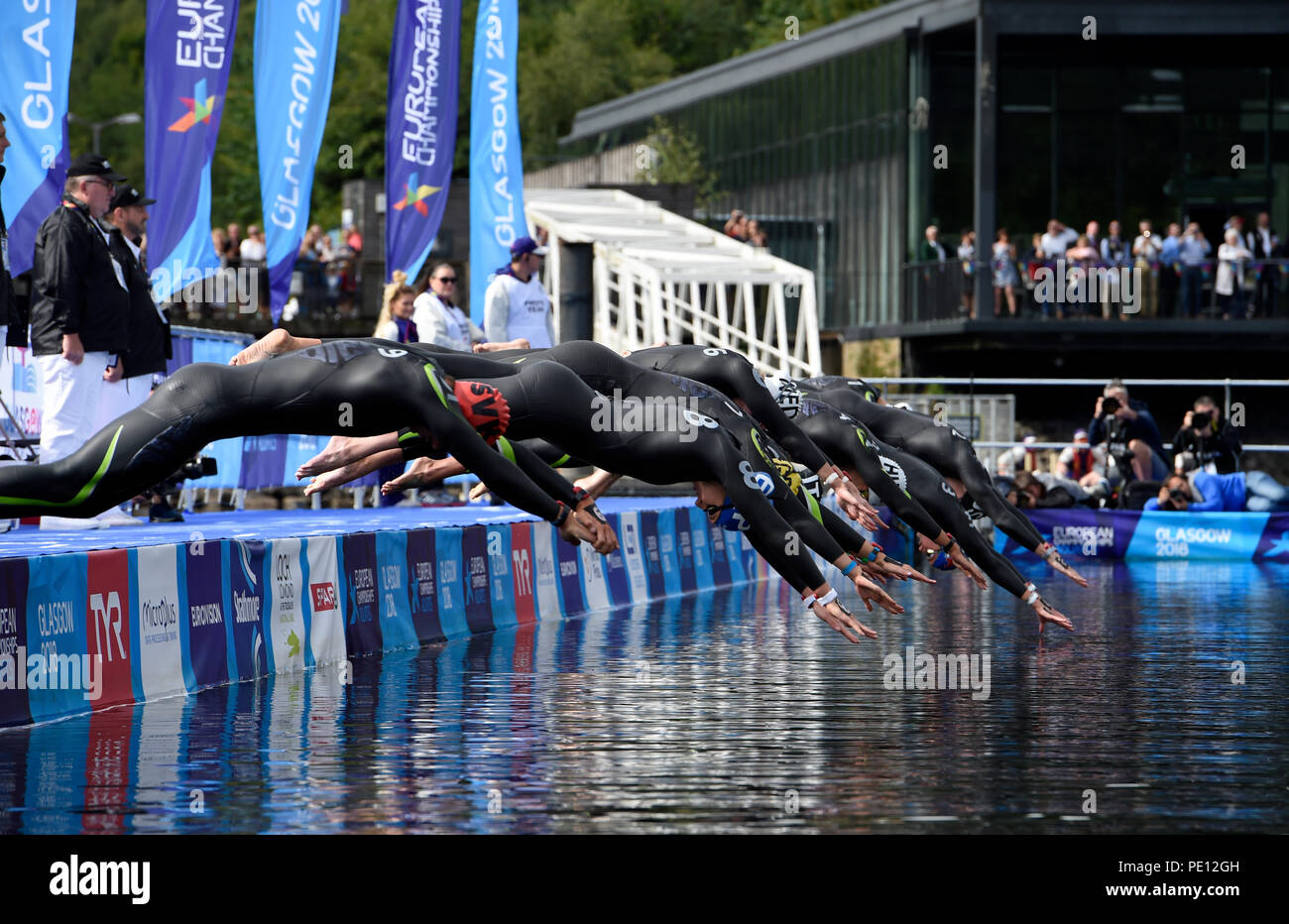 Swimmers dive in at the start of the Mixed Relay during day ten of the 2018 European Championships at Loch Lomond, Stirling. PRESS ASSOCIATION Photo. Picture date: Saturday August 11, 2018. See PA story OPEN European. Photo credit should read: Ian Rutherford/PA Wire. Stock Photo