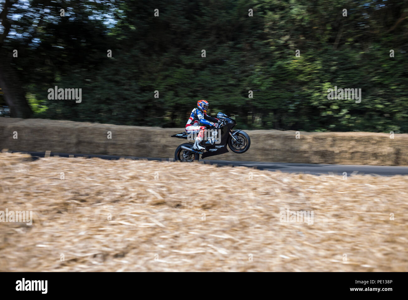 A motorbike speeds up the Hillclimb at the Goodwood Festival of Speed 2018. Stock Photo