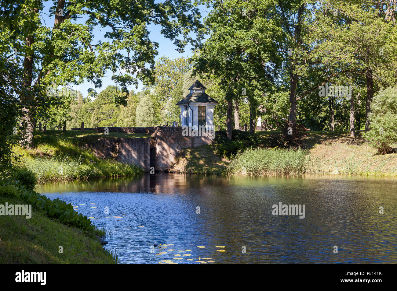 Small chapel on the bank of the lake Stock Photo - Alamy