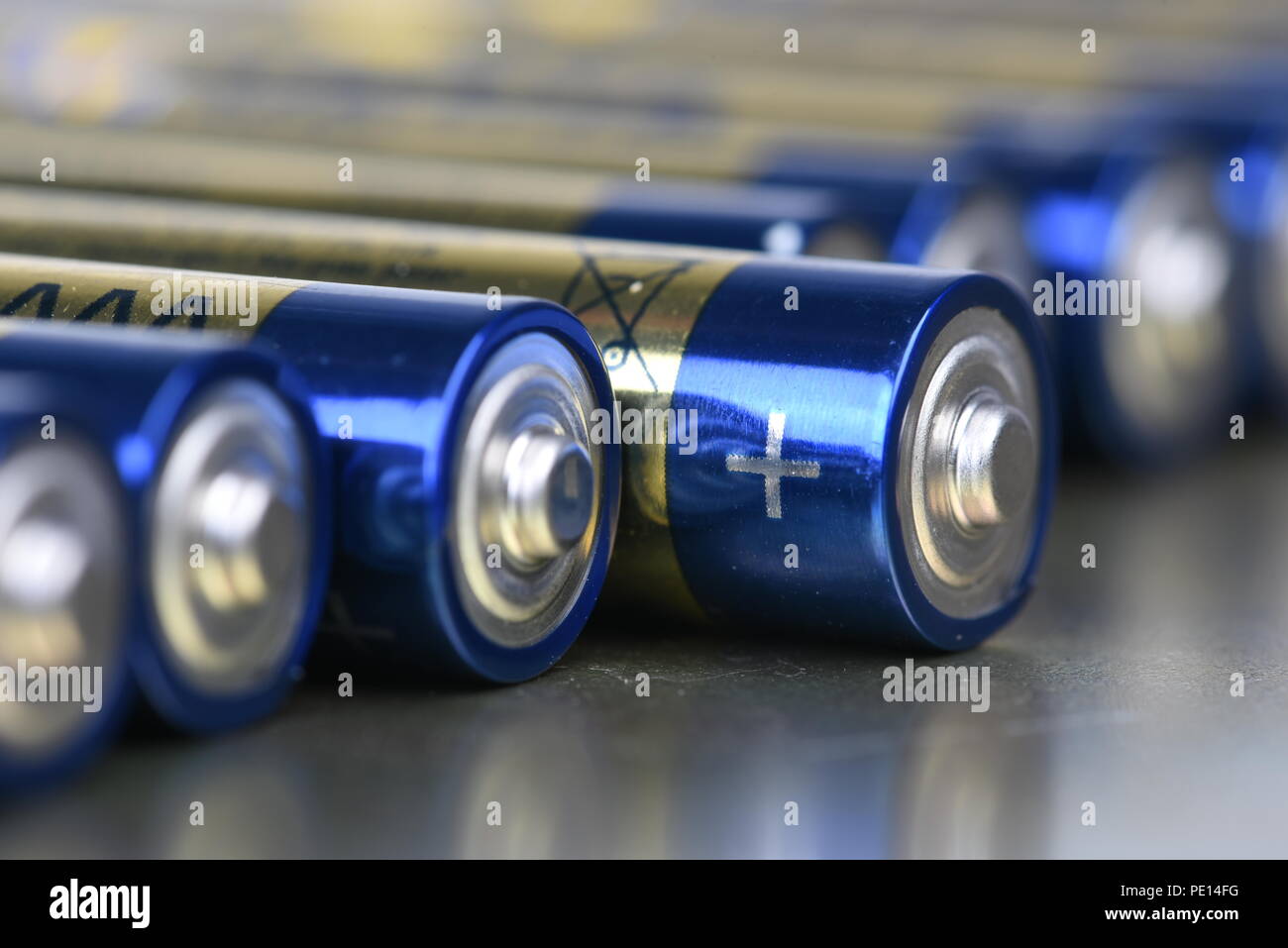 AAA alkaline batteries in perspective on metal background Stock Photo