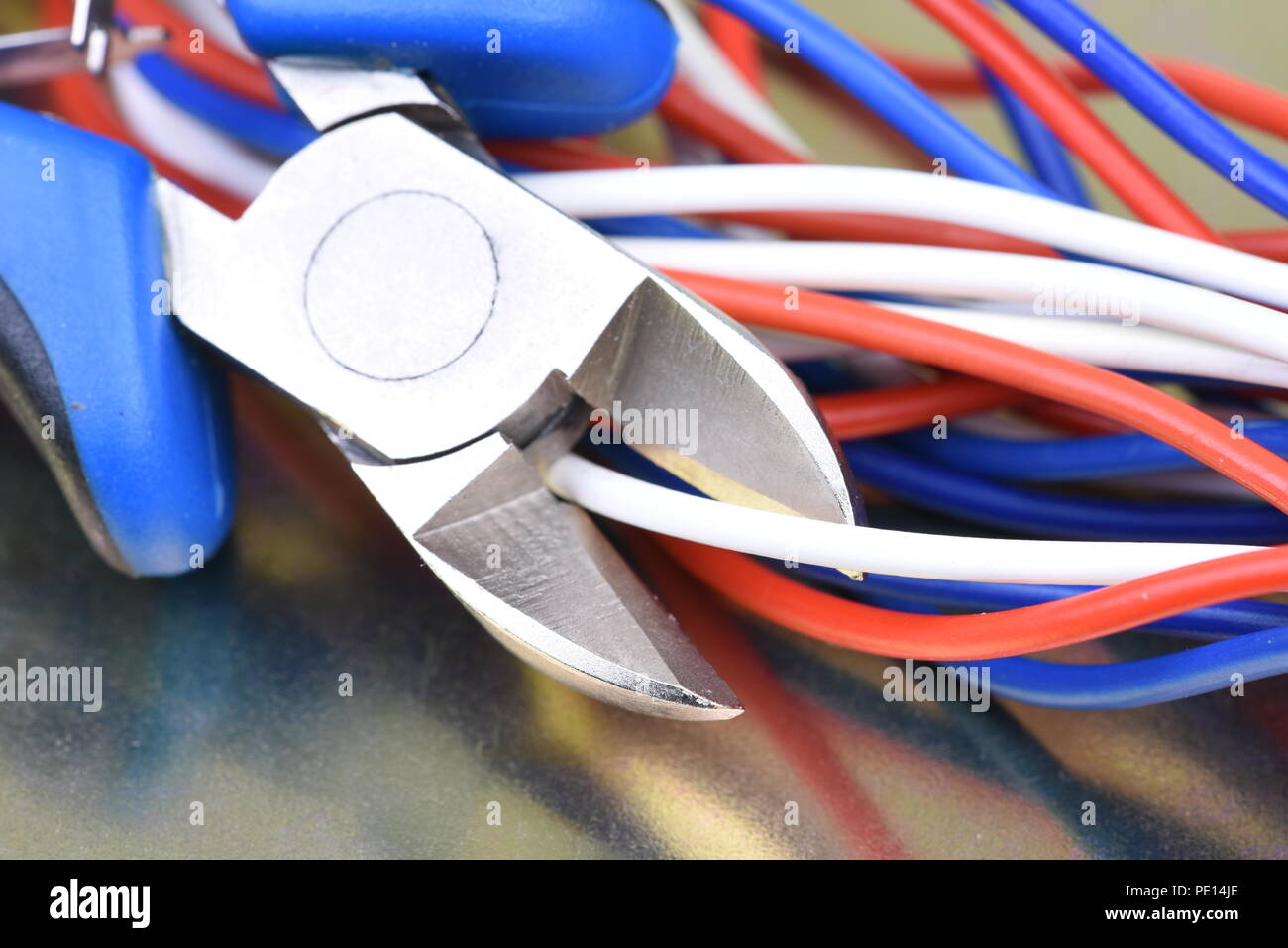 Pliers cutting electrical wires closeup Stock Photo