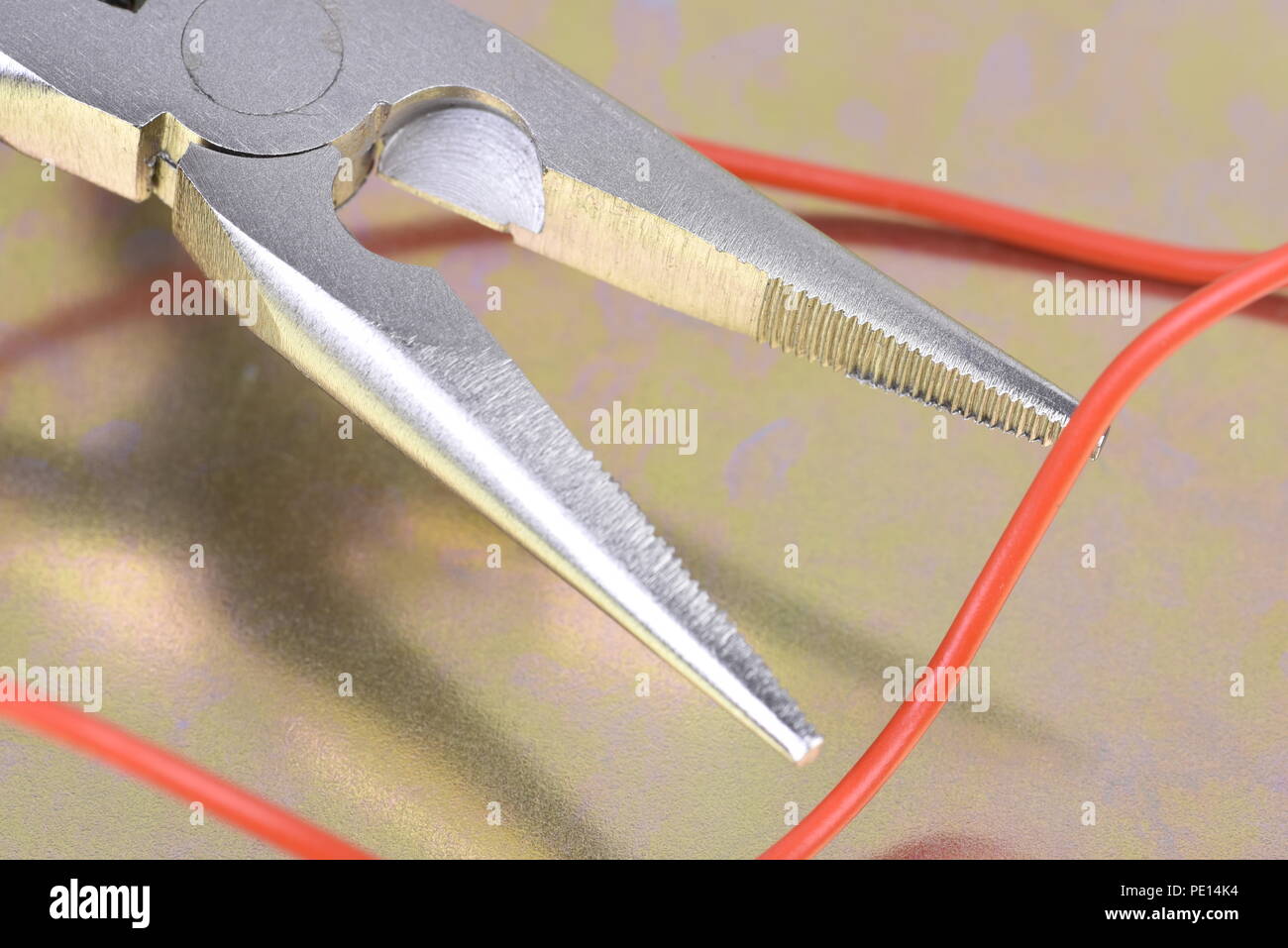 Electric pliers and wire close-up Stock Photo