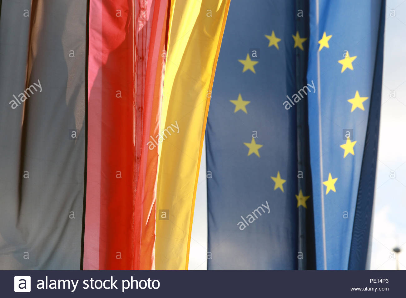 The EU and German flags hang side by side in Coburg, Germany Stock Photo