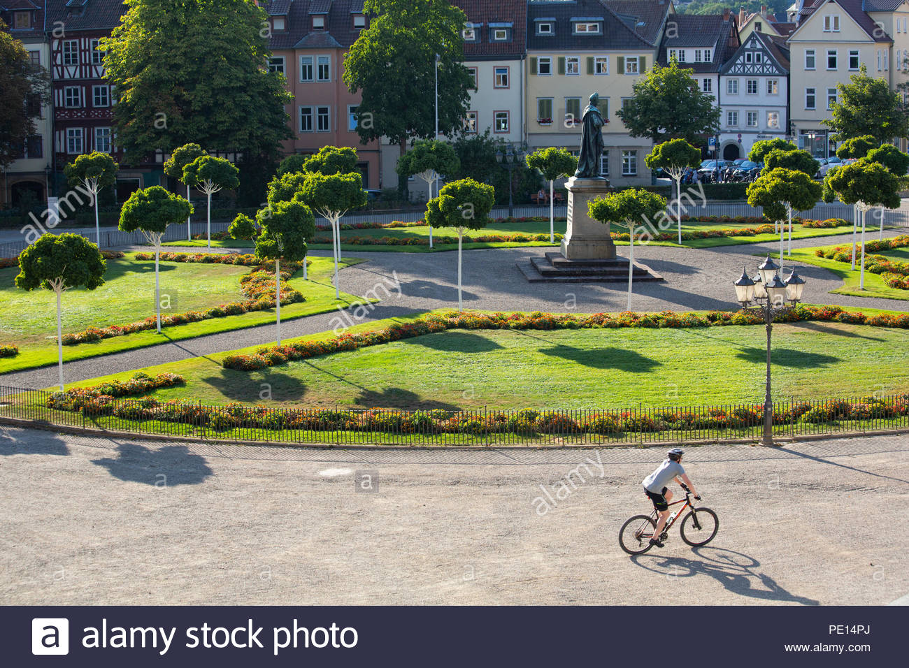 A view of a section of Castle Square (Schlossplatz) in the Franconian town of Coburg, Germany on a sunny day with shadows and a statue to Ernst I. Stock Photo