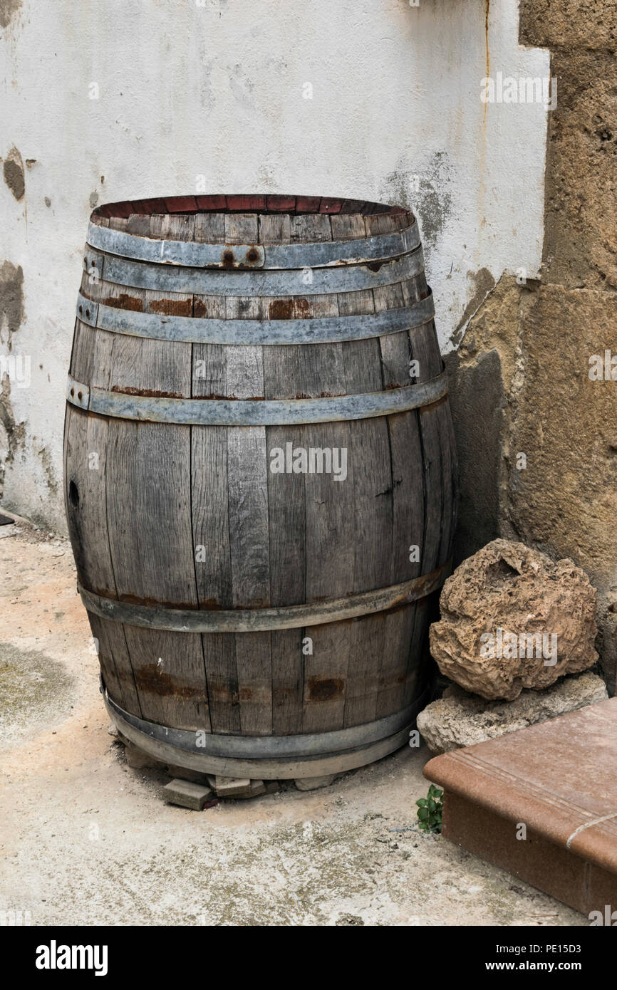 Barrel to stand liquids with alcohol that is old and used as decoration. Stock Photo