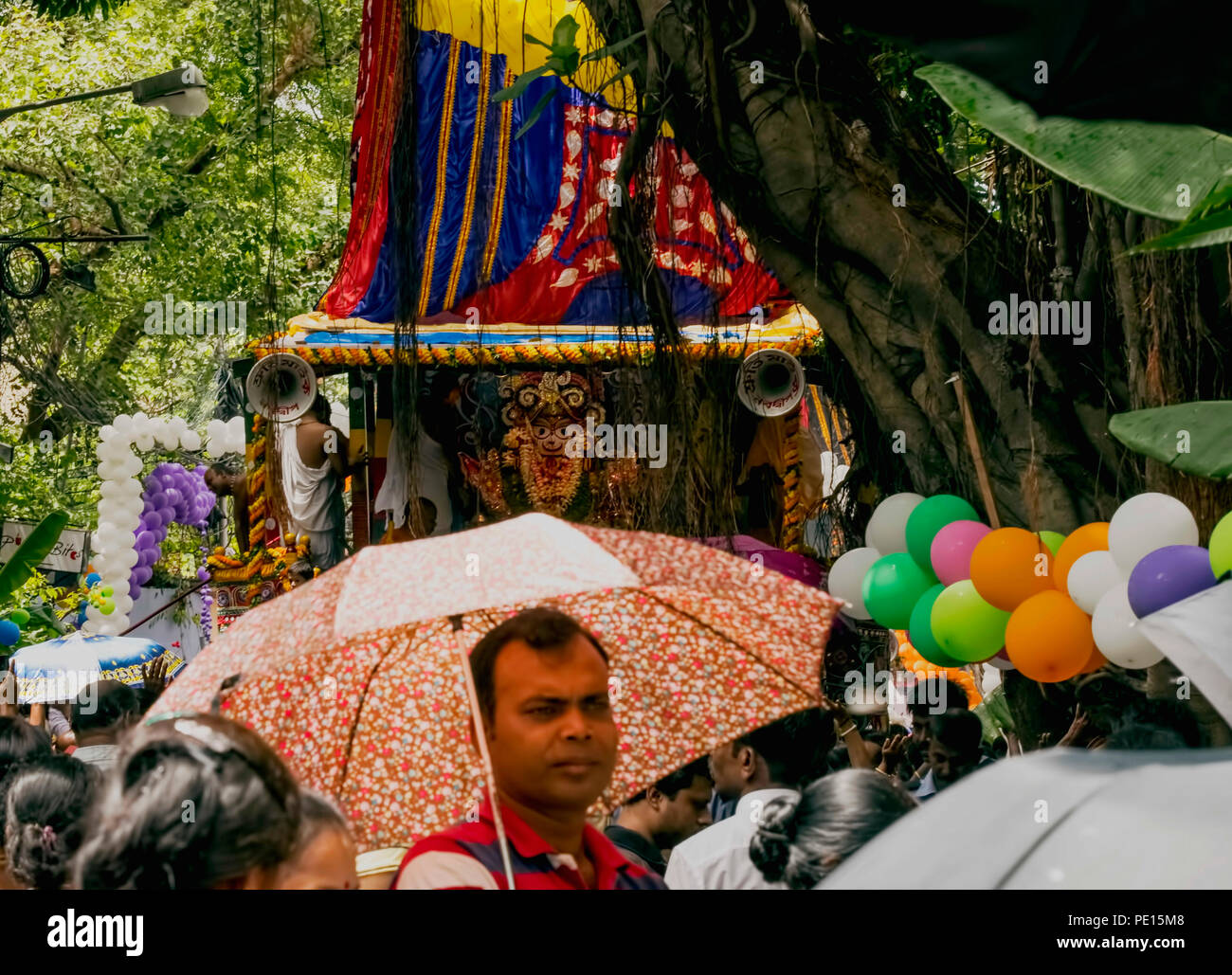 Goddess Subhadra,sister ,Lord Jagannatha,seated,in Her Ratha,Car,for journey toAunt,s  residence,Kolkata,India.Aman with umbrella,in Her front Stock Photo