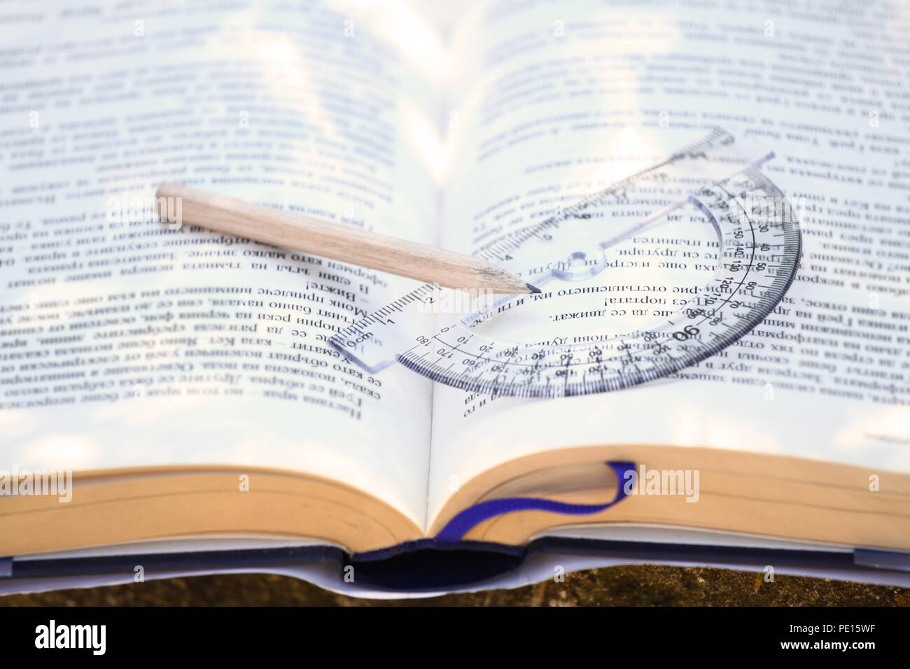 Back to school concept. Education and nature. Open book with pencil outdoor. Time for school and reading. Learning outside. Schoolbook and pen. Pencil Stock Photo