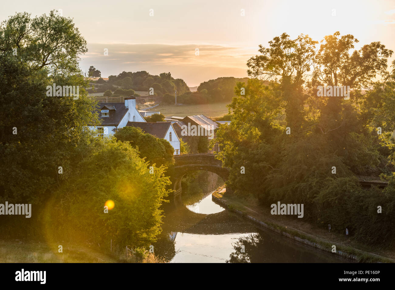 Sunset view flying midges over British rural landscape scene with river near Northampton. Stock Photo