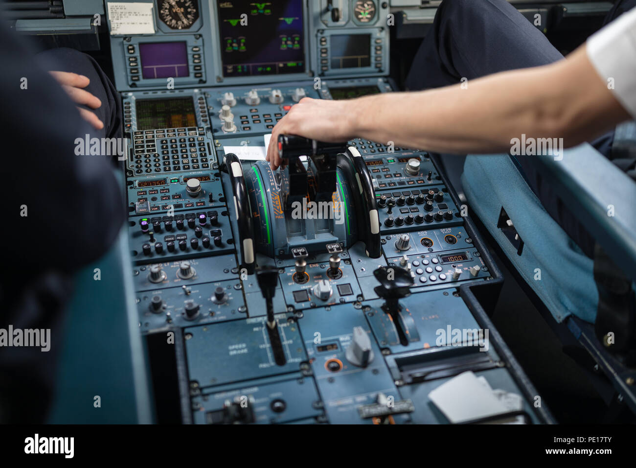 Pilot's hand accelerating on the throttle in a commercial airliner