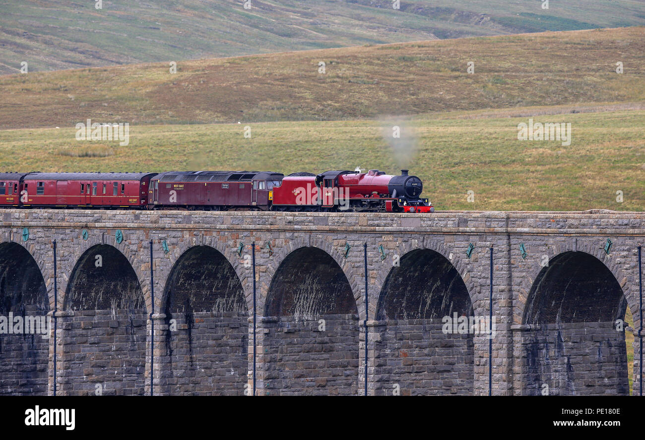 The Cumbrian Mountain Express, pulled by historic steam locomotive No 45699 Galatea, crosses the Ribblehead Viaduct in North Yorkshire as railway enthusiasts mark the 50th anniversary of the end of regular mainline steam services. Stock Photo