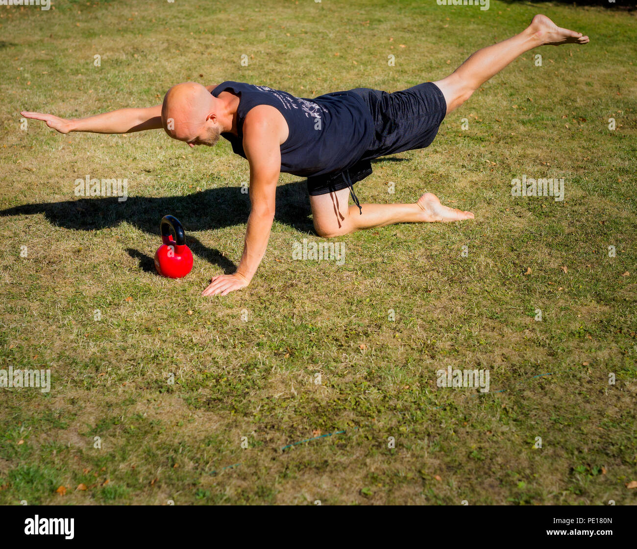 Young man doing back training outdoors Stock Photo