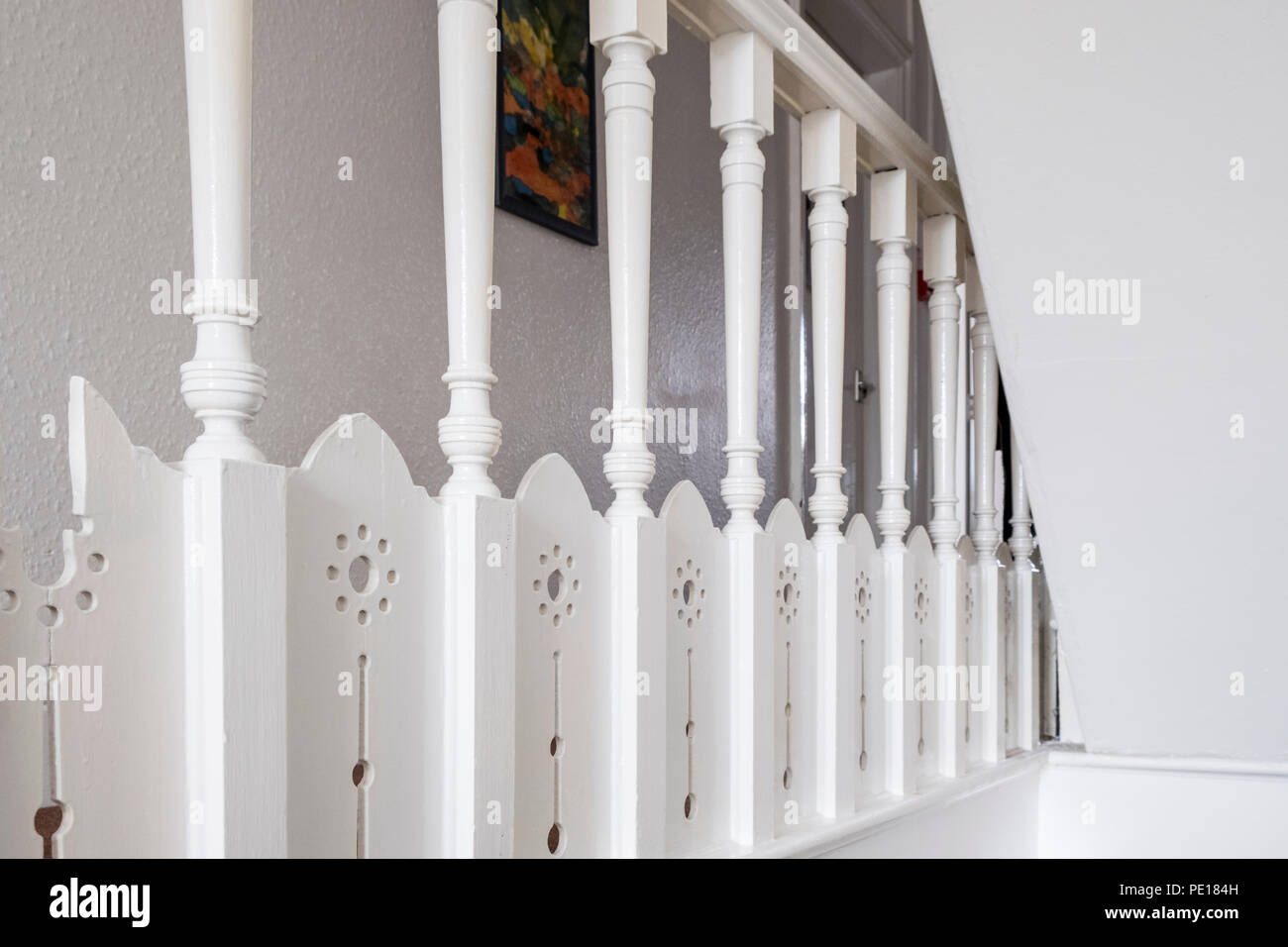 Detail of balusters supporting the handrail or bannister of the balustrade on the landing of a staircase Stock Photo
