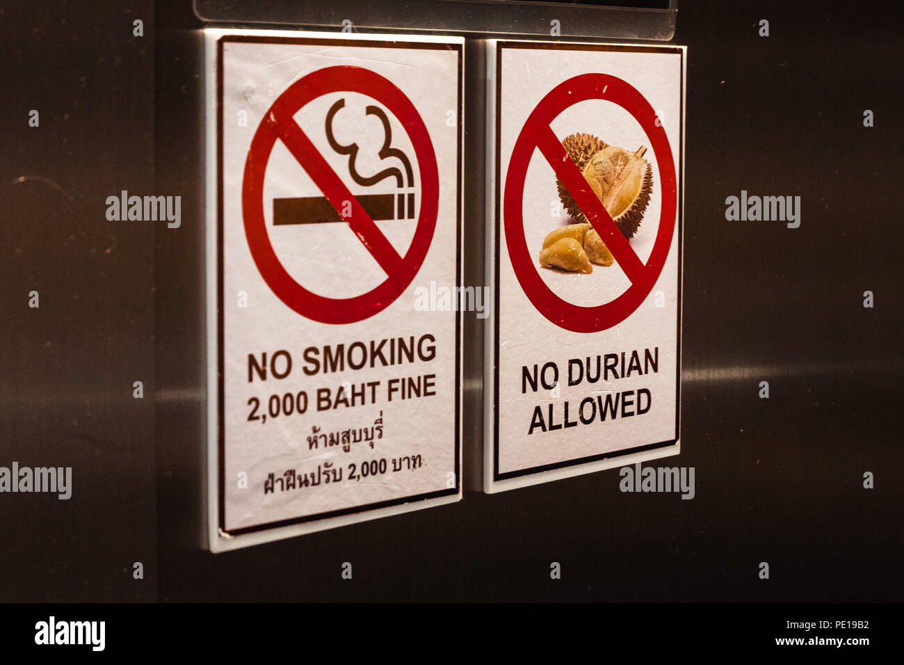 Signs in a hotel in Bangkok, Thailand, advising visitors not to smoke to bring durian fruit inside Stock Photo