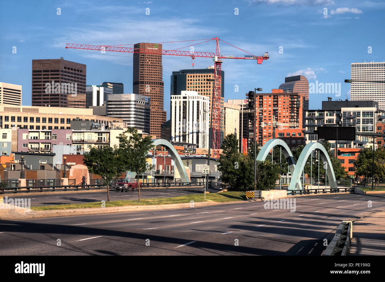 Construction cranes dot the downtown Denver skyline.  Downtown Denver seen from the Speer Blvd overpass. Stock Photo