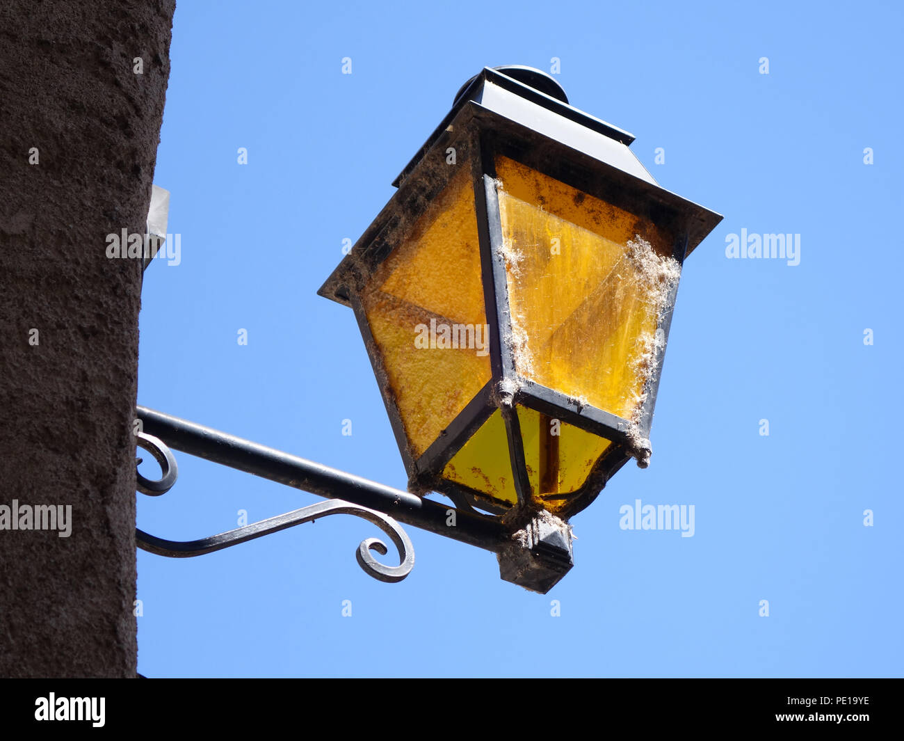 Old fashioned wall mounted street lamp in CessenonsurOrb, France