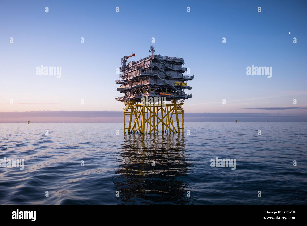 The offshore substation Z04 on Walney Extension Offshore Wind Farm at dawn Stock Photo