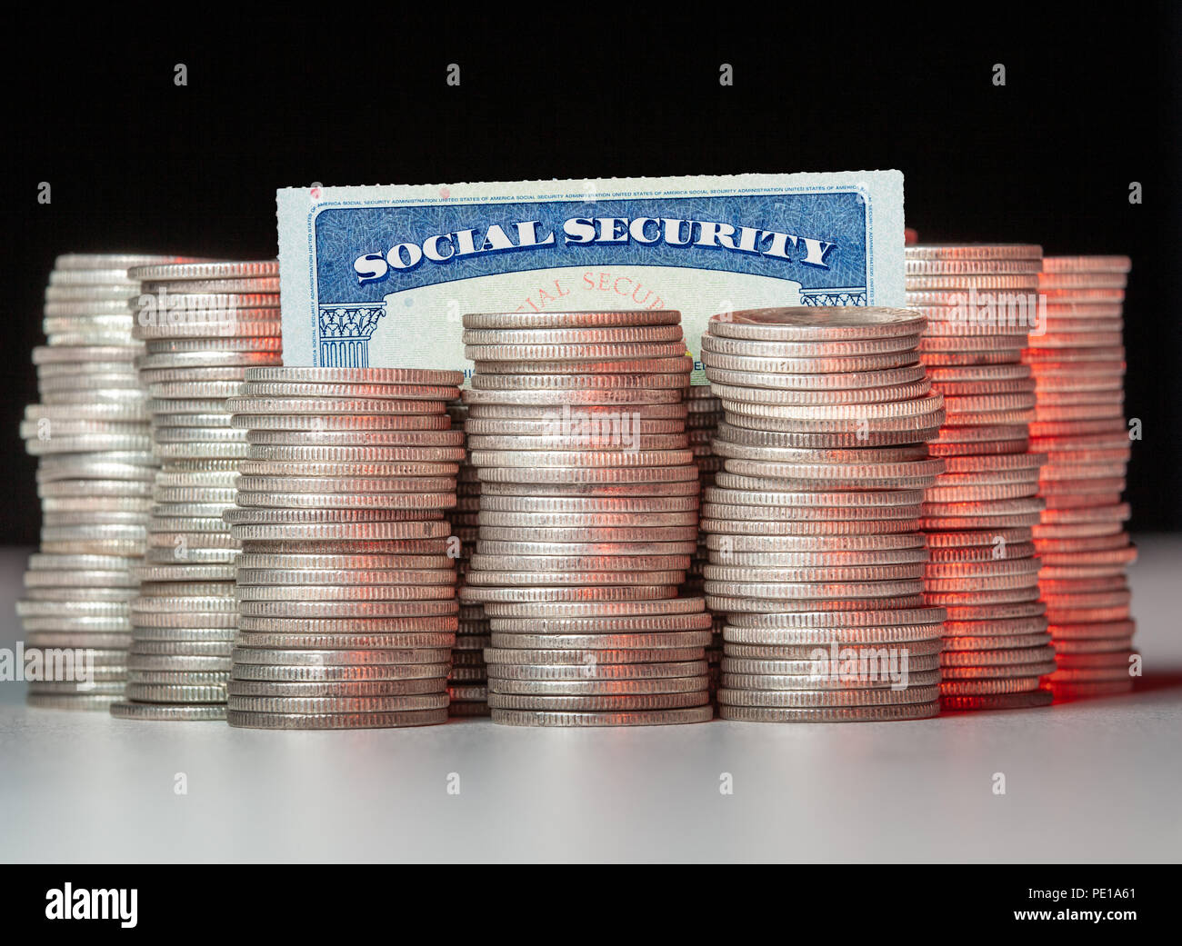 Stacks of pure silver coins with social security card Stock Photo