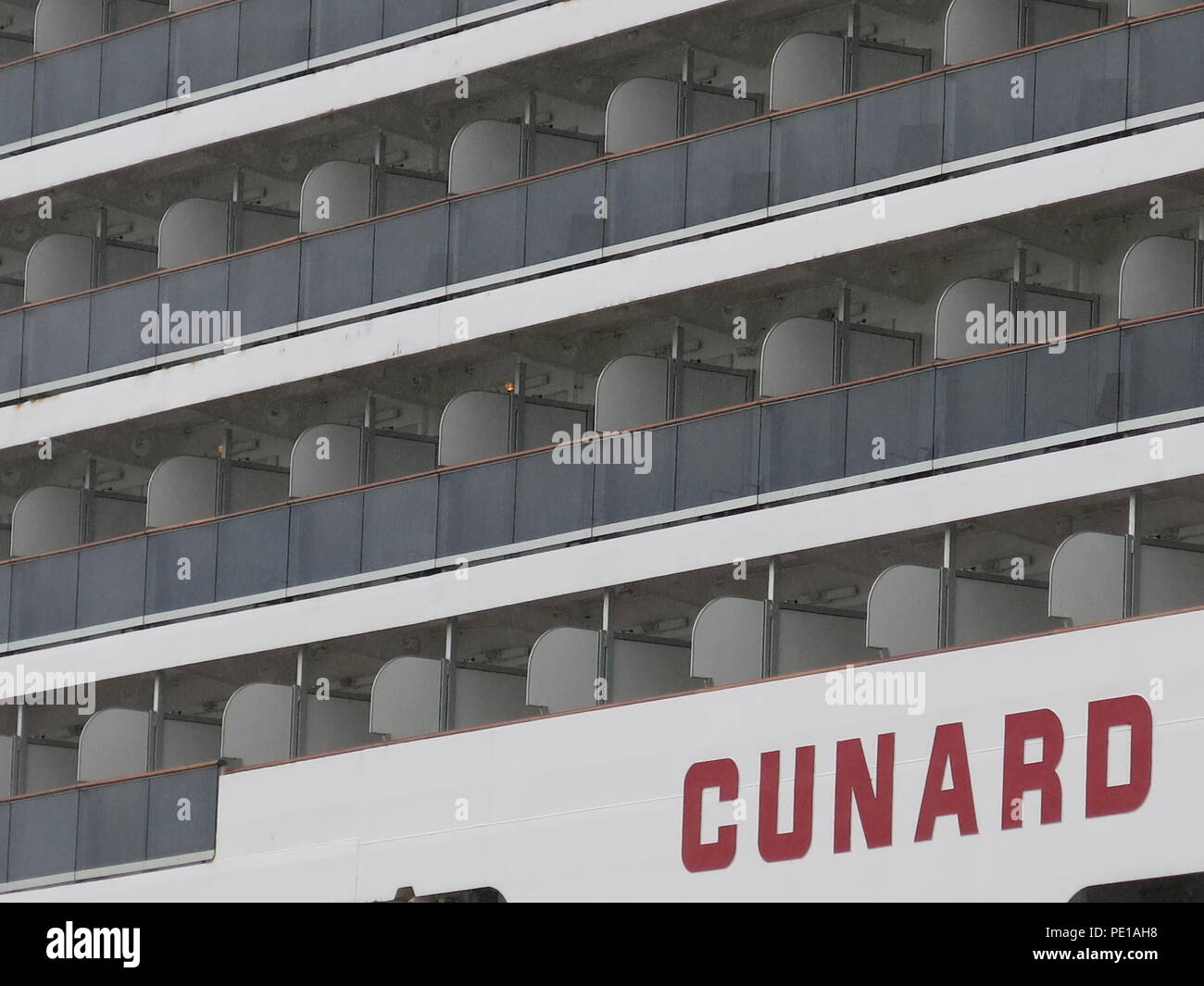 A closeup of the rows of cabins on three decks on the starboard side
