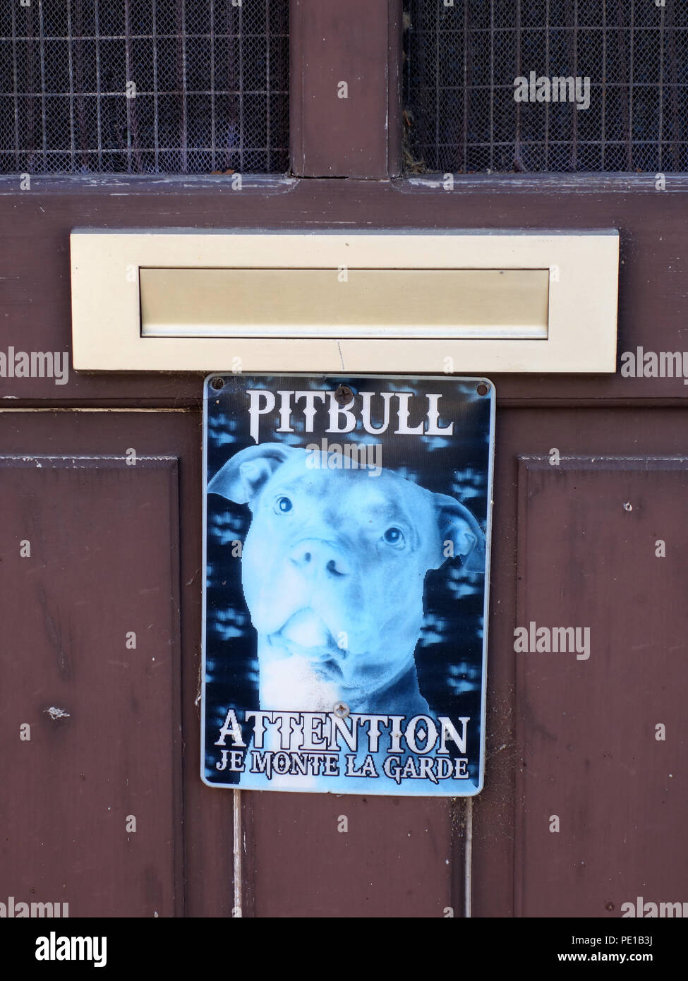 Beware of the pitbull warning sign on a house door in Cessenon-sur-Orb, France Stock Photo