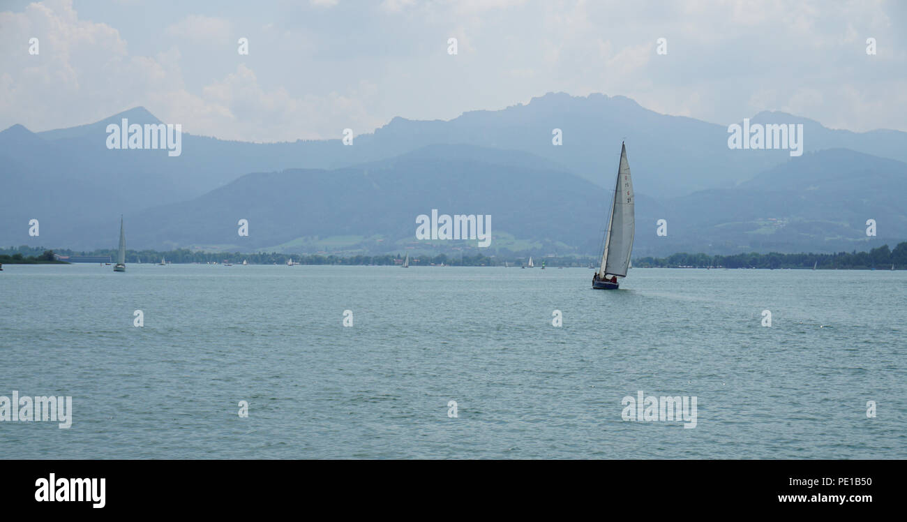 sailing boat at lake with mountains in background Stock Photo - Alamy