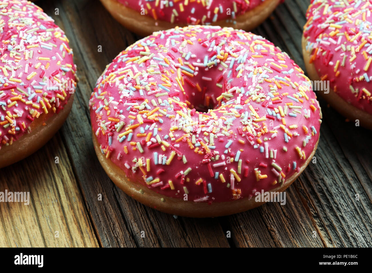 assorted donuts with chocolate frosted, pink glazed and sprinkles ...