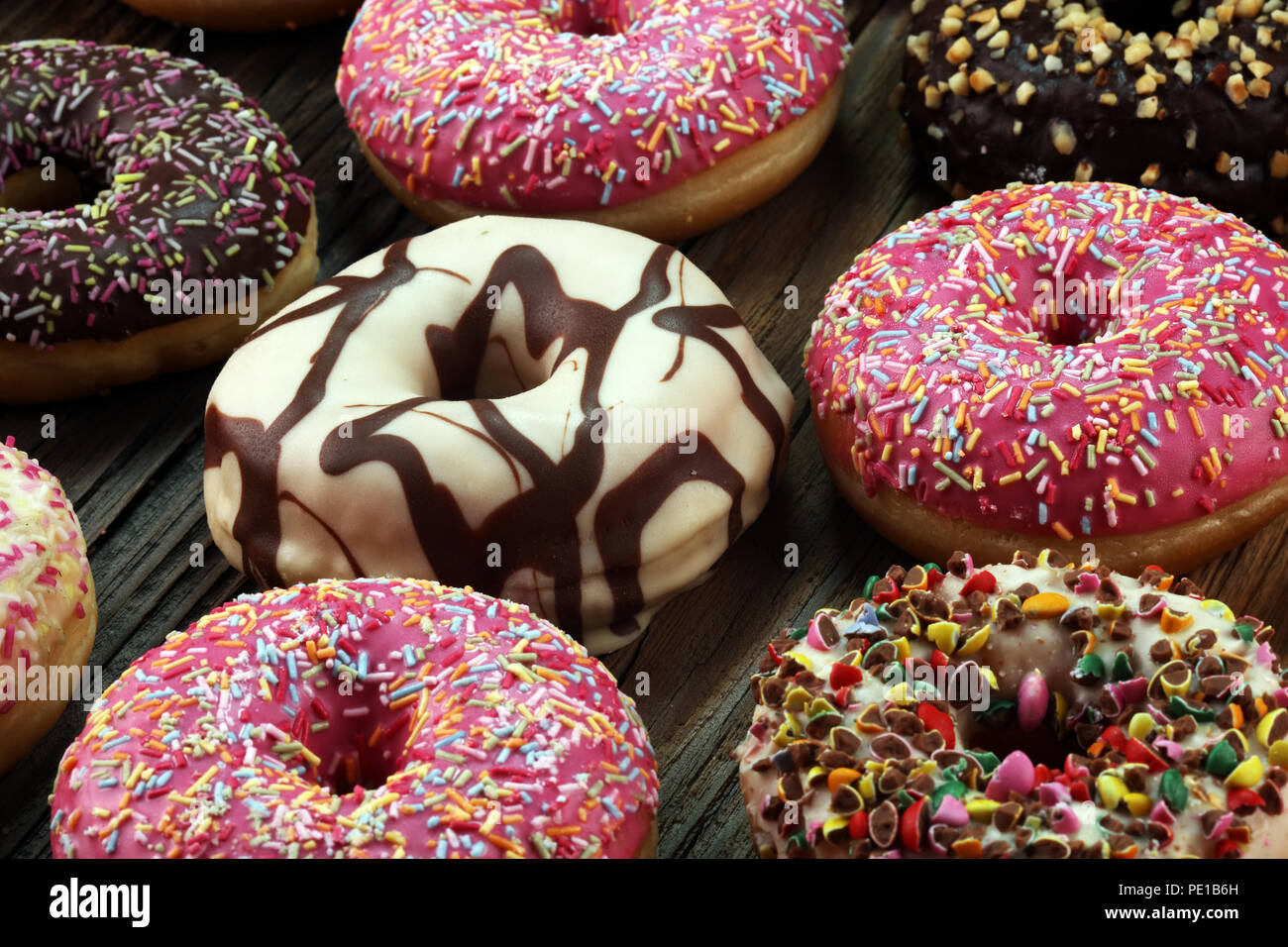 assorted donuts with chocolate frosted, pink glazed and sprinkles ...