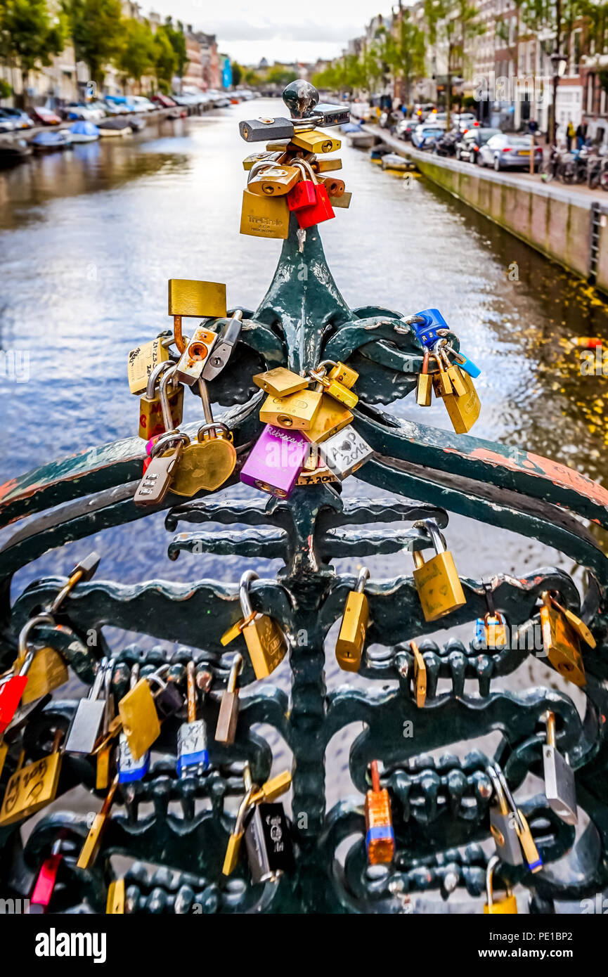 Love Padlocks on a railing of a bridge over the Keizersgracht in the old city center of Amsterdam in North Holland, the Netherlands Stock Photo