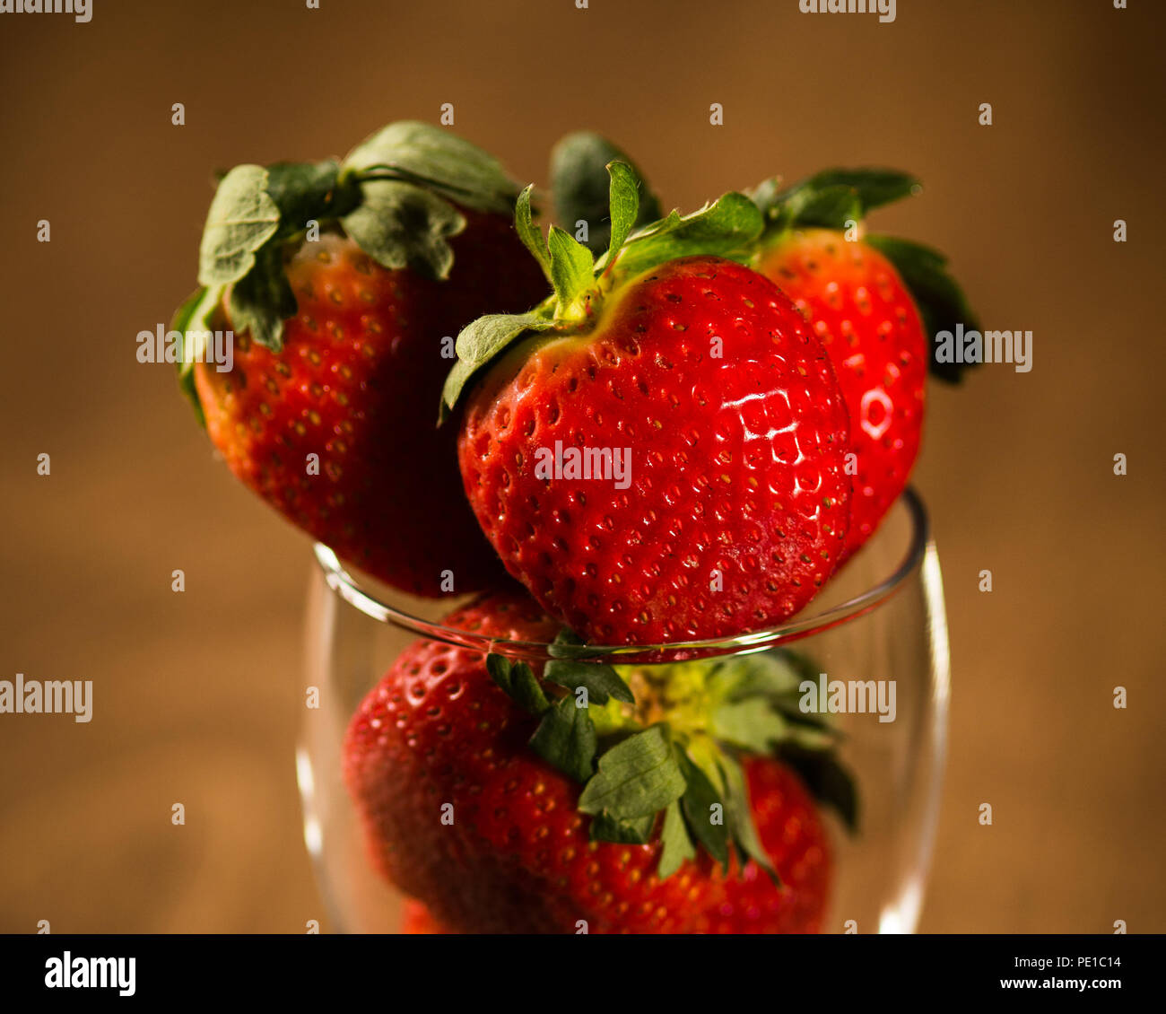 strawberries in a glass with a wood table top background Stock Photo ...