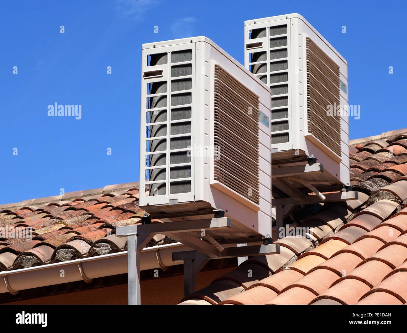 Two roof mounted air conditioning units on a house roof in Cessenonsur
