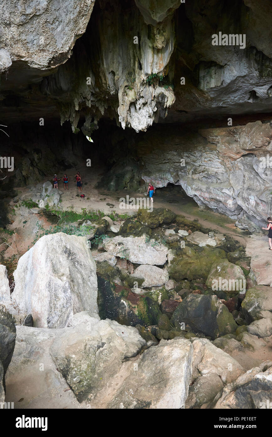 A small group of people exploring the a cave in Halong Bay in North Vietnam. Stock Photo