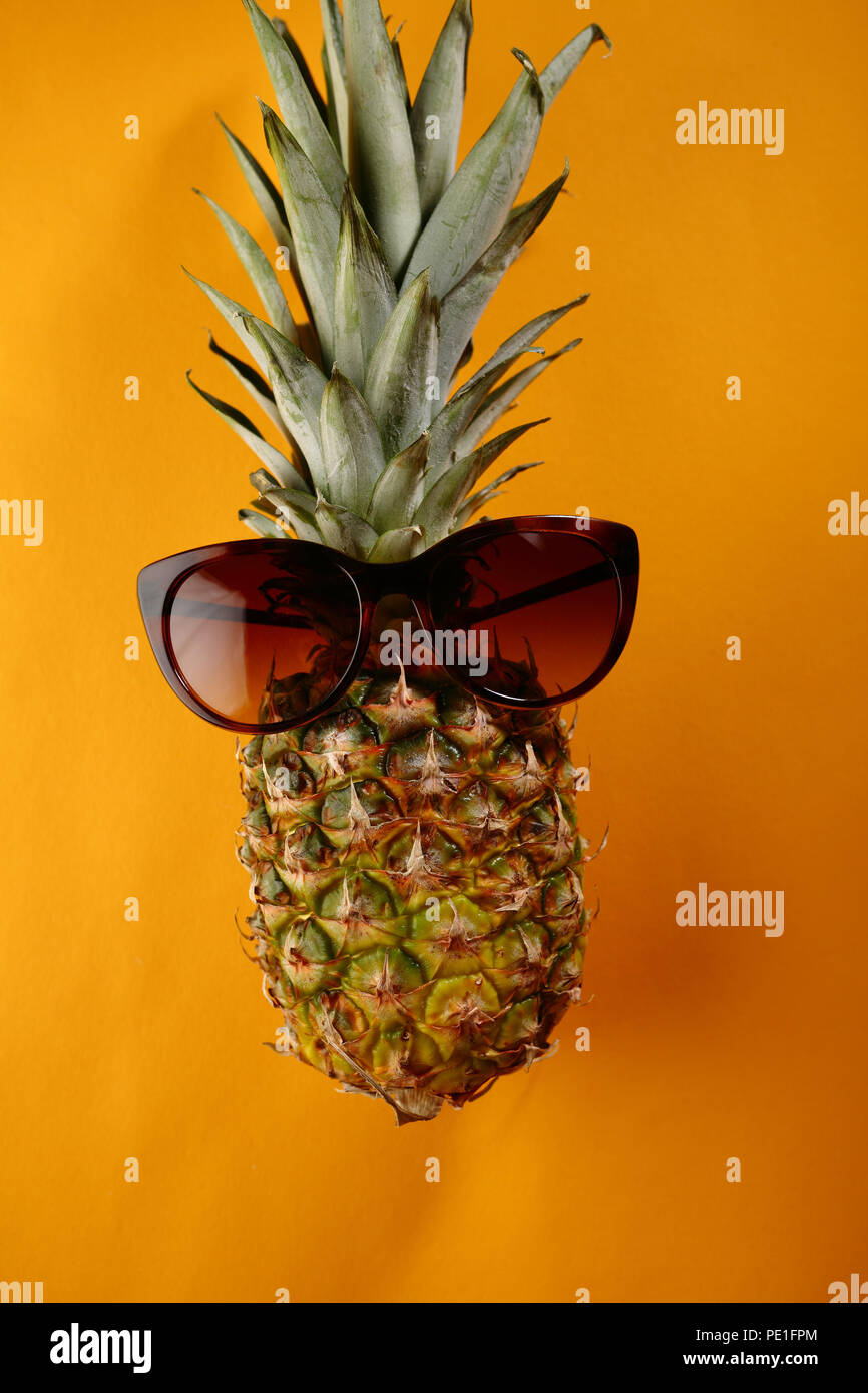 Pineapple with sunglasses on yellow background Stock Photo Alamy