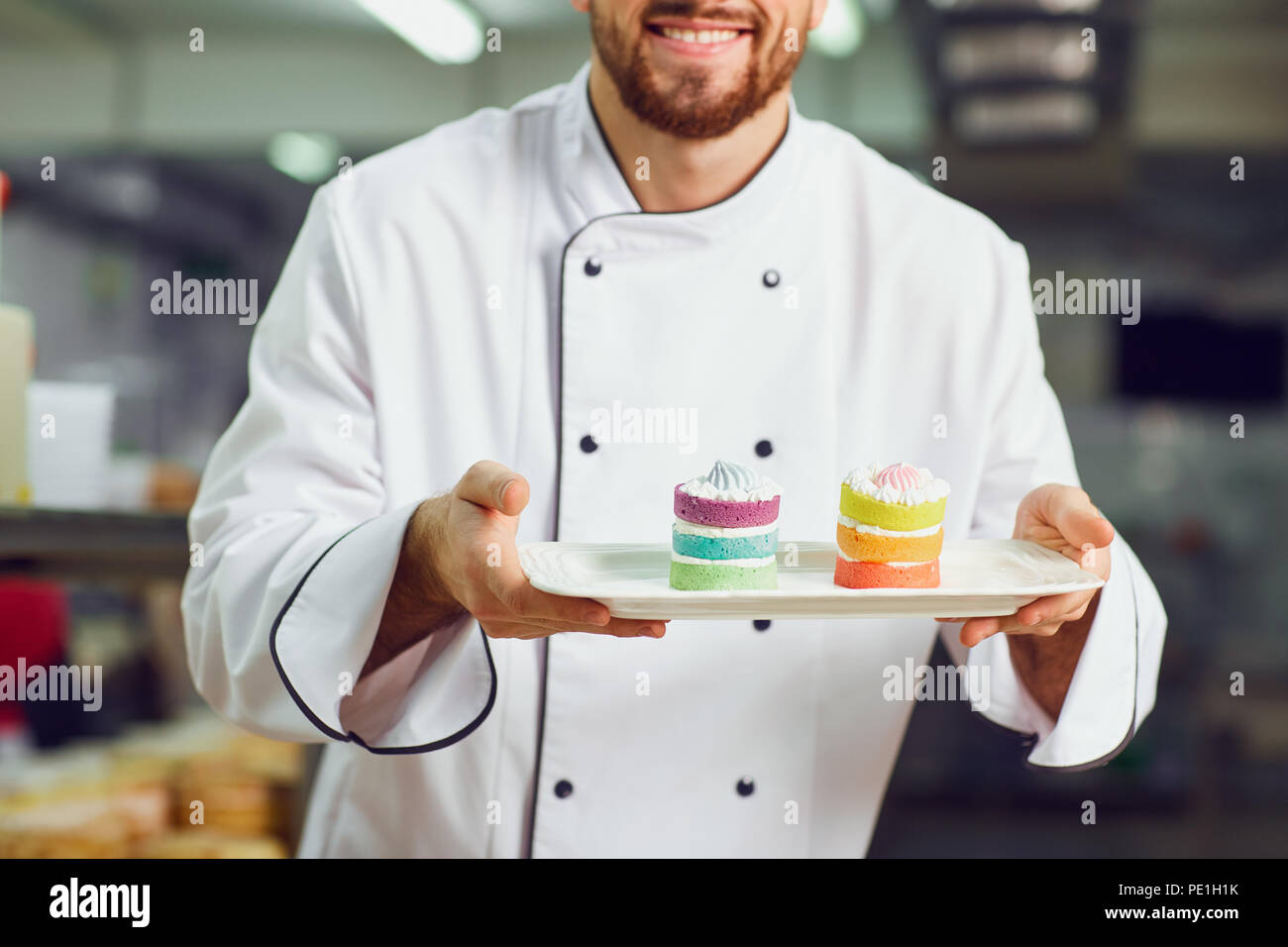 A confectioner with dessert in his hands. Stock Photo