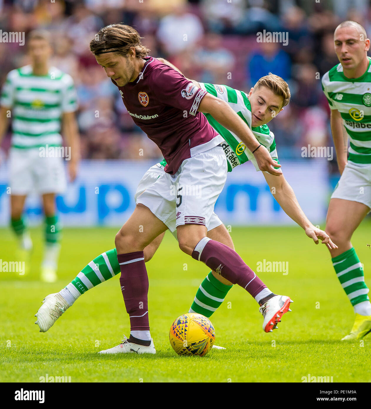 Hearts' Peter Haring and Cetic's James Forrest compete for the ball during the Ladbrokes Scottish Premiership match at Tynecastle Stadium, Edinburgh. PRESS ASSOCIATION Photo. Picture date: Saturday August 11, 2018. See PA story soccer Hearts. Photo credit should read: Craig Watson/PA Wire. EDITORIAL USE ONLY Stock Photo