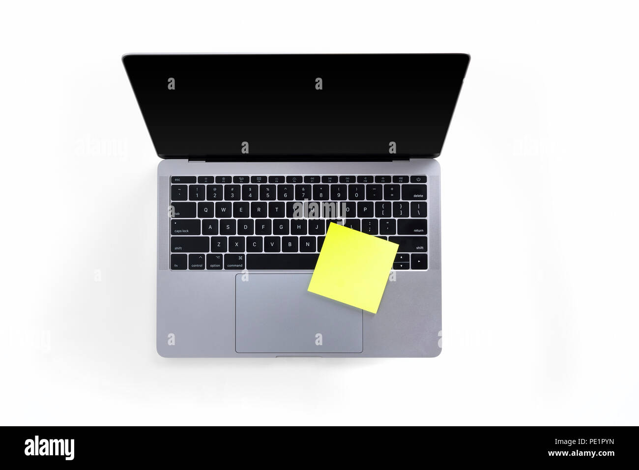 Top view of tabletop with laptop and post it notes isolated on white