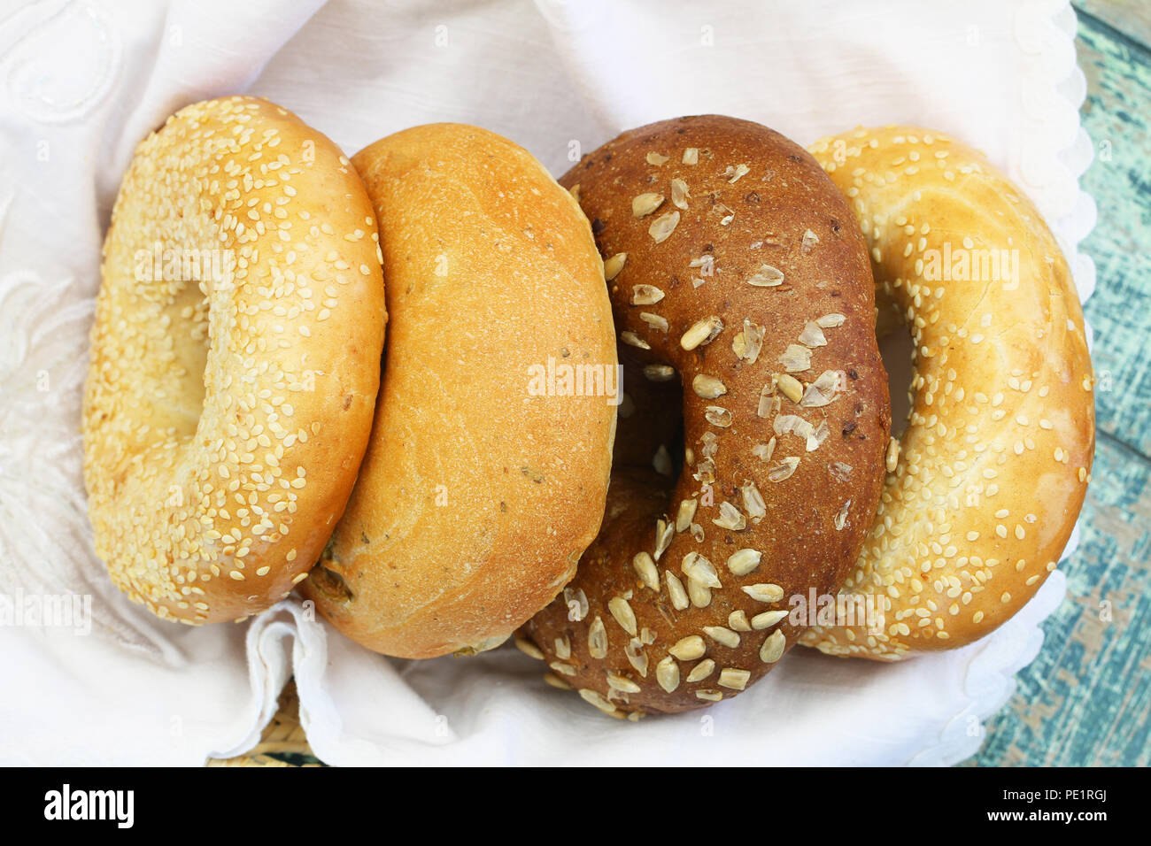 Selection of white and brown bagels in bread basket shot from the top, closeup Stock Photo