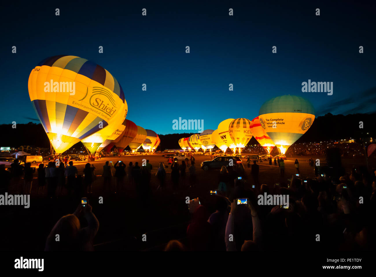 Night Glow in the evening of the Bristol International Balloon Fiesta. A number of balloons performed at night to music using their gas burners Stock Photo