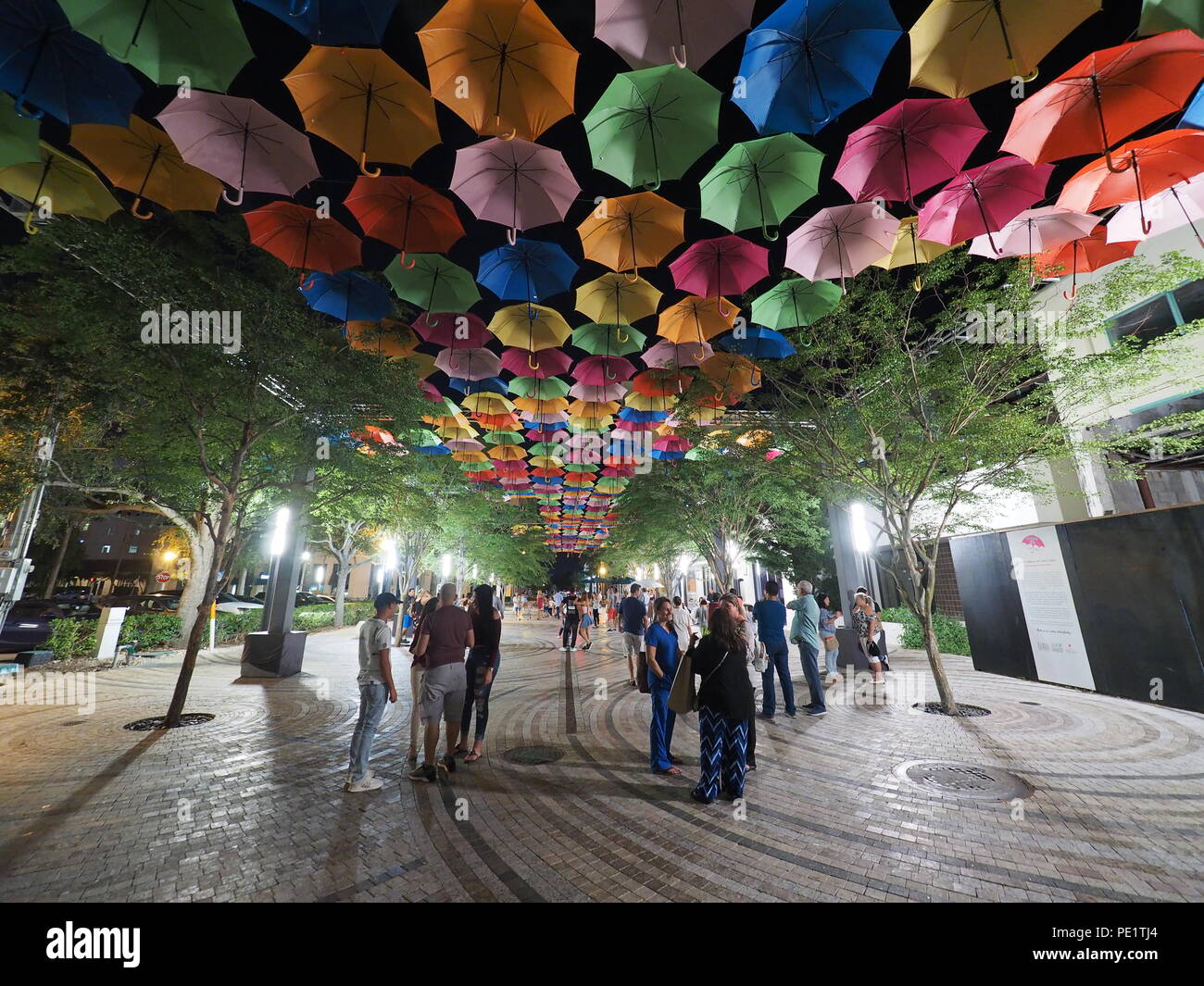 Umbrella Sky in Coral Gables, Florida, a joint art project by the City of Coral Gables and the Portuguese company Sextafeira, at night.. Stock Photo