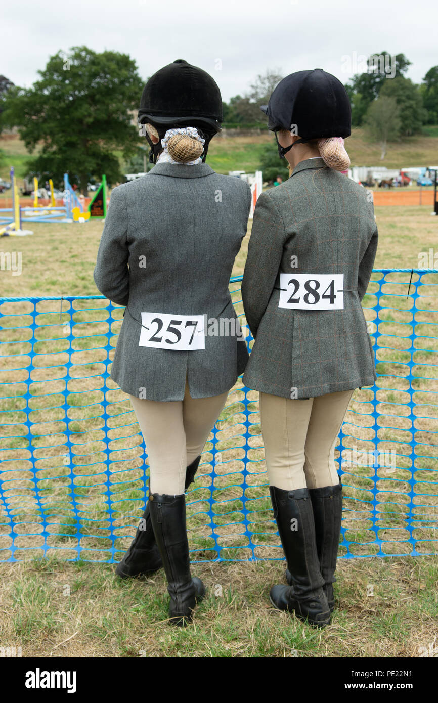 Junior girls awaiting their turn in the show jumping at the annual Ellingham and Ringwood Agricultural Society Show in the rural west of the county of Hampshire, UK Stock Photo