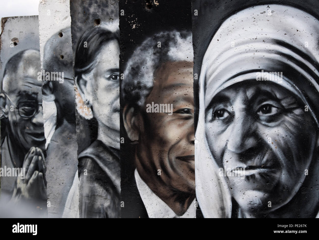 Teltow, Germany. 10th Aug, 2018. Painted remains of the former Berlin Wall  show paintings by Mother Teresa and Nelson Mandela, among others, created  by the Spanish artist Victor Landeta. The Berlin Wall