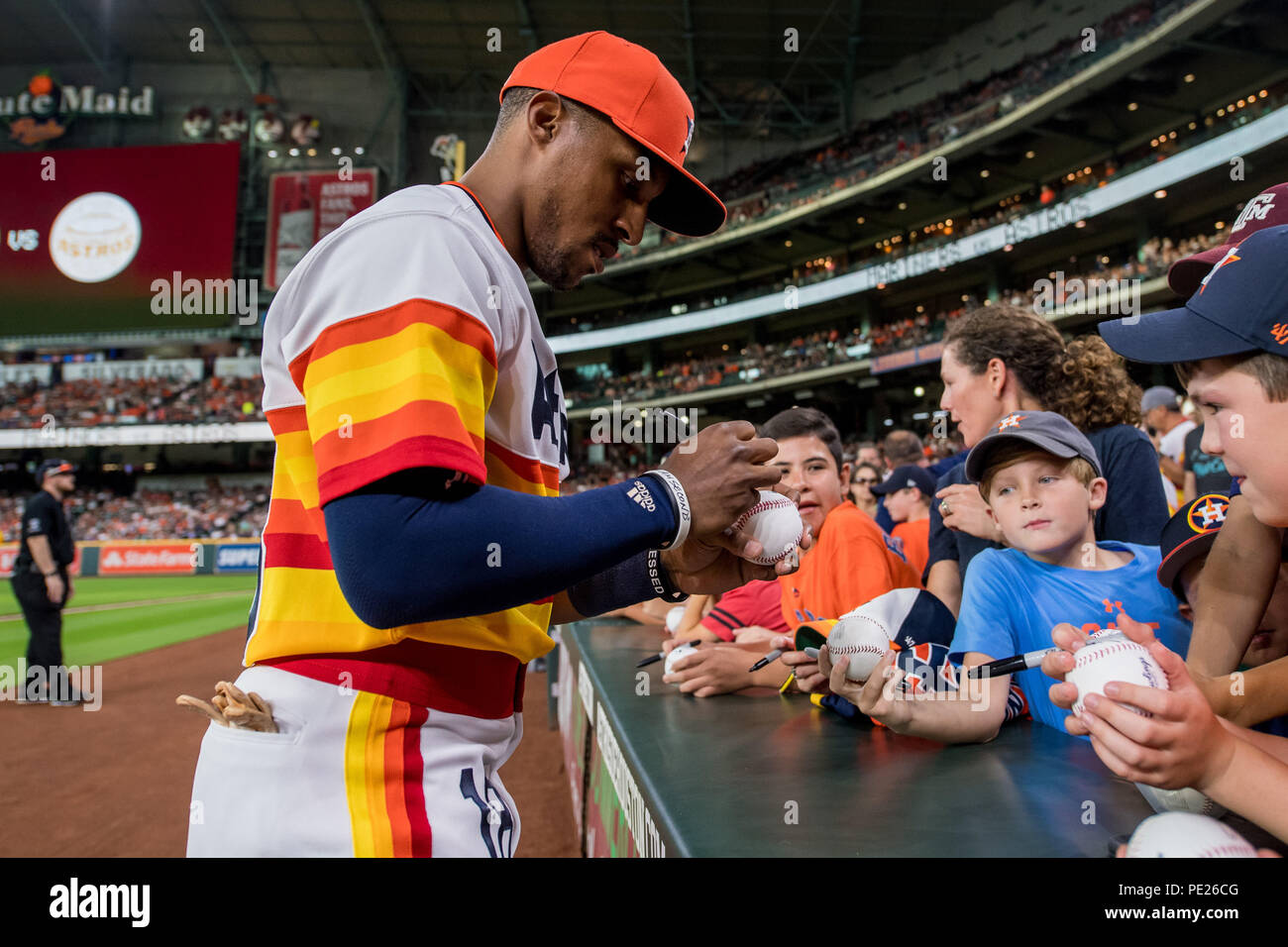 August 10, 2018: Houston Astros left fielder Tony Kemp (18) signs baseballs  for fans prior to a Major League Baseball game between the Houston Astros  and the Seattle Mariners on 1970s night