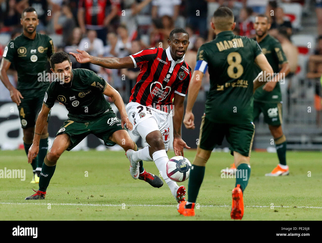 Nice, France. 11th Aug, 2018. Wylan Cyprien (C) of Nice vies with Xavier  Chavalerin (2nd L) of Reims during the French Ligue 1 football match  2018-19 season 1st round in Nice, France