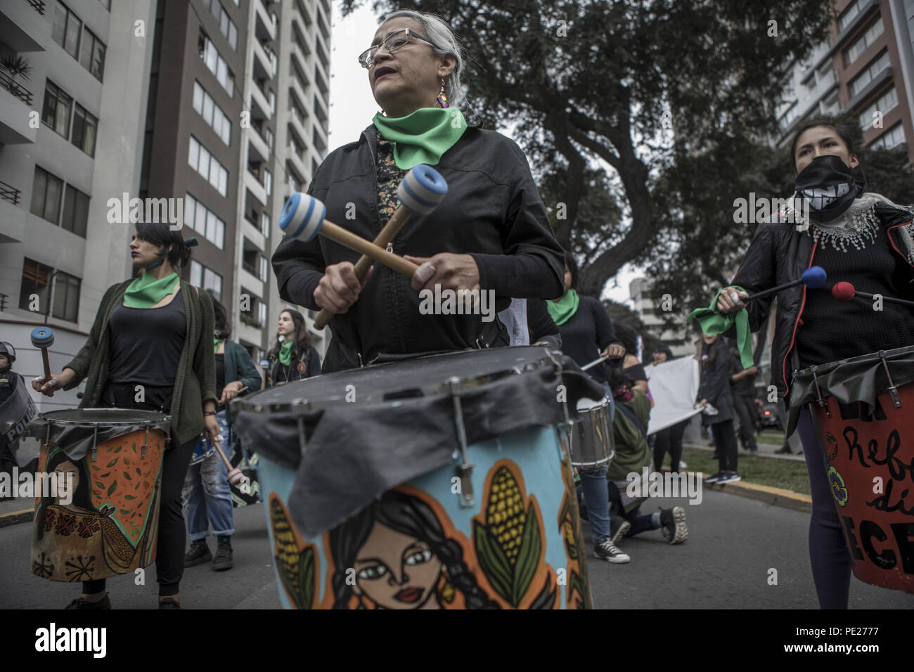 Lima, Peru. 11th Aug, 2018. Demonstrators march while paying music during a Ni Una Menos (Not One Less) rally in protest of gender based violence in Lima. Ni Una Menos (Not One Less) demands that women should be protected from violent deaths at the hands of men in Peru. Credit: Guillermo Gutierrez/SOPA Images/ZUMA Wire/Alamy Live News Stock Photo