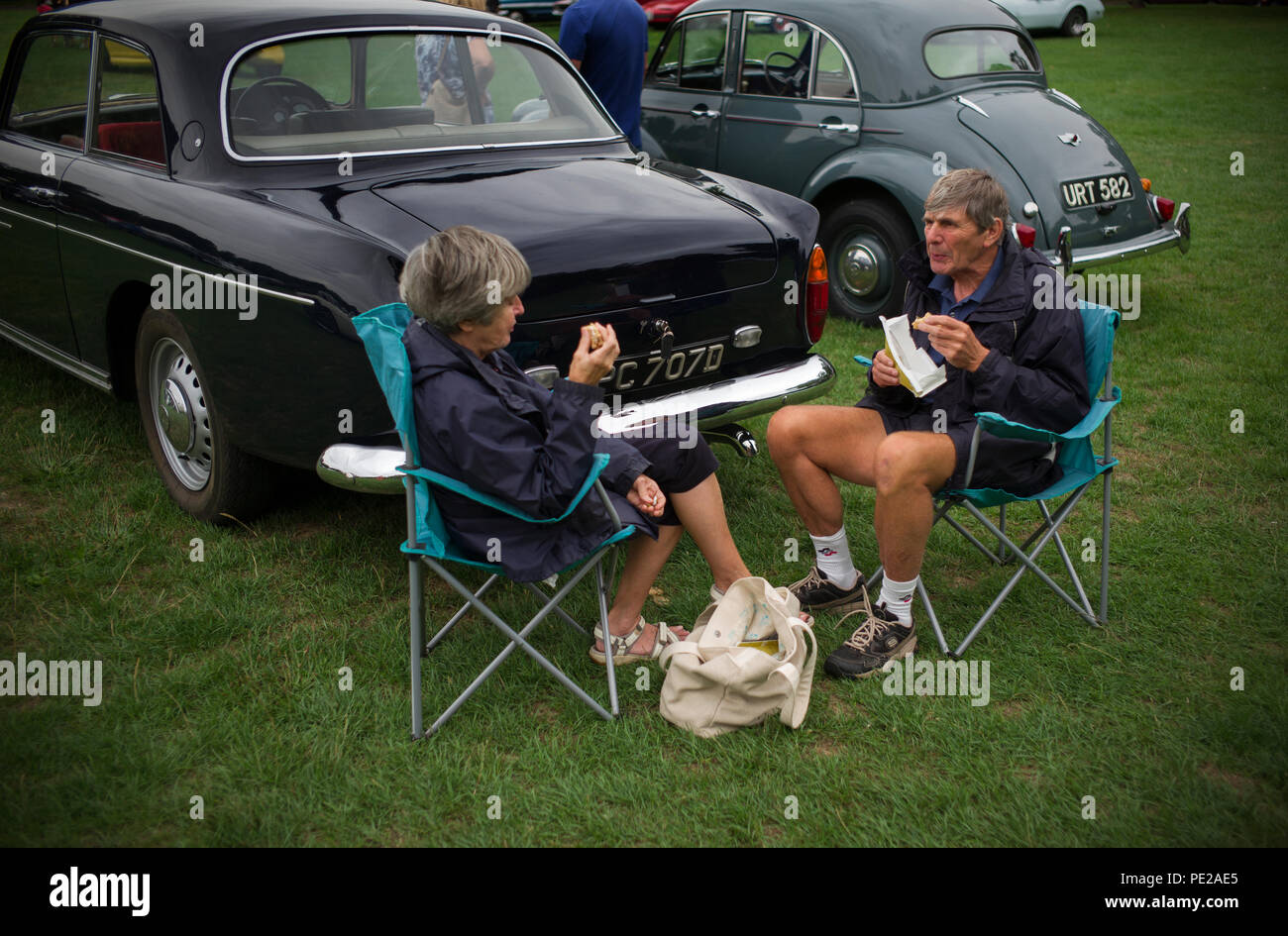 Essex, UK. 12th August 2018. Saffron Walden Motor Show 12 August 2018 Lunch being taken by those exhibiting their classic and vintage cars. More than 500 classic and vintage cars, motor bikes were on display at the annual Saffron Walden Motor Show on Saffron walden common. Money raised goes to the Arthur Rank Hospice and Riding for the disabled in nearby Radwinter. Credit: BRIAN HARRIS/Alamy Live News Stock Photo