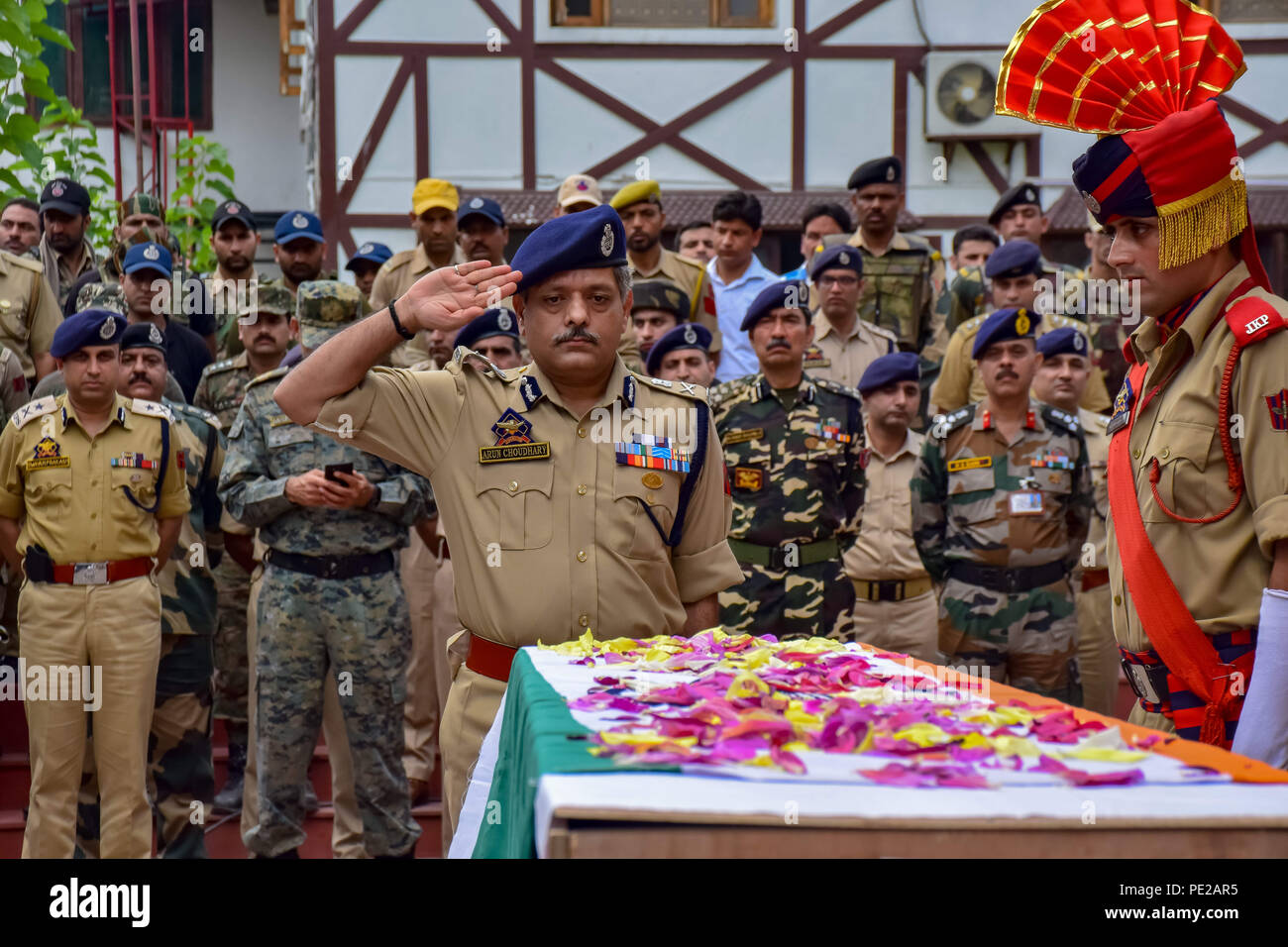 August 12, 2018 - Srinagar, Jammu & Kashmir, India - Indian police officer salute during the wreath-laying ceremony of their colleague Parvaiz Ahmad in Srinagar. A gunfight between rebels and raiding government forces at a neighborhood in Indian-controlled Kashmir's main city on Sunday has killed a counterinsurgency police official and wounded at least three other security officials, police said.A gunfight between rebels and raiding government forces at a neighborhood in Indian-controlled Kashmir's main city on Sunday has killed a counter insurgency police official and wounded at least three Stock Photo