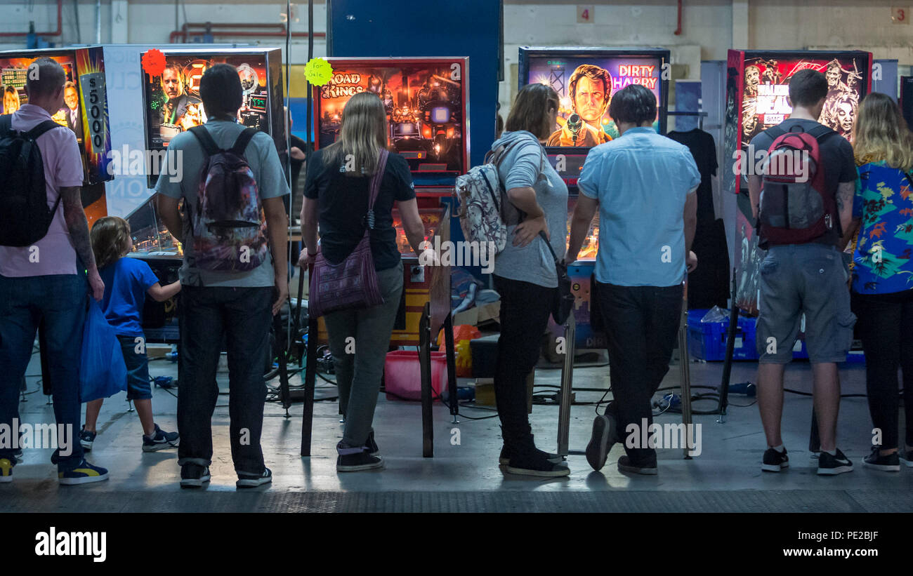London, UK.  12 August 2018. Visitors play pinball at retro games festival PLAY Expo held in London for the first time at Printworks, Canada Water. Game enthusiasts visited to rediscover the classics, from Donkey Kong, Pong, Super Mario Bros. and Space Invaders to vintage pinball machines, VR, indie games and a dedicated Minecraft zone. The show also included a sneak preview of new retro gaming streaming service, Antstream.  Credit: Stephen Chung / Alamy Live News Stock Photo