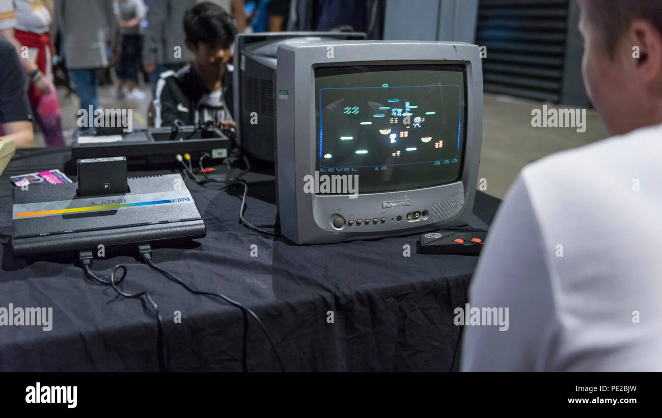 London, UK.  12 August 2018. A visitor plays a game on an Atari 7800 console at retro games festival PLAY Expo held in London for the first time at Printworks, Canada Water. Game enthusiasts visited to rediscover the classics, from Donkey Kong, Pong, Super Mario Bros. and Space Invaders to vintage pinball machines, VR, indie games and a dedicated Minecraft zone. The show also included a sneak preview of new retro gaming streaming service, Antstream.  Credit: Stephen Chung / Alamy Live News Stock Photo