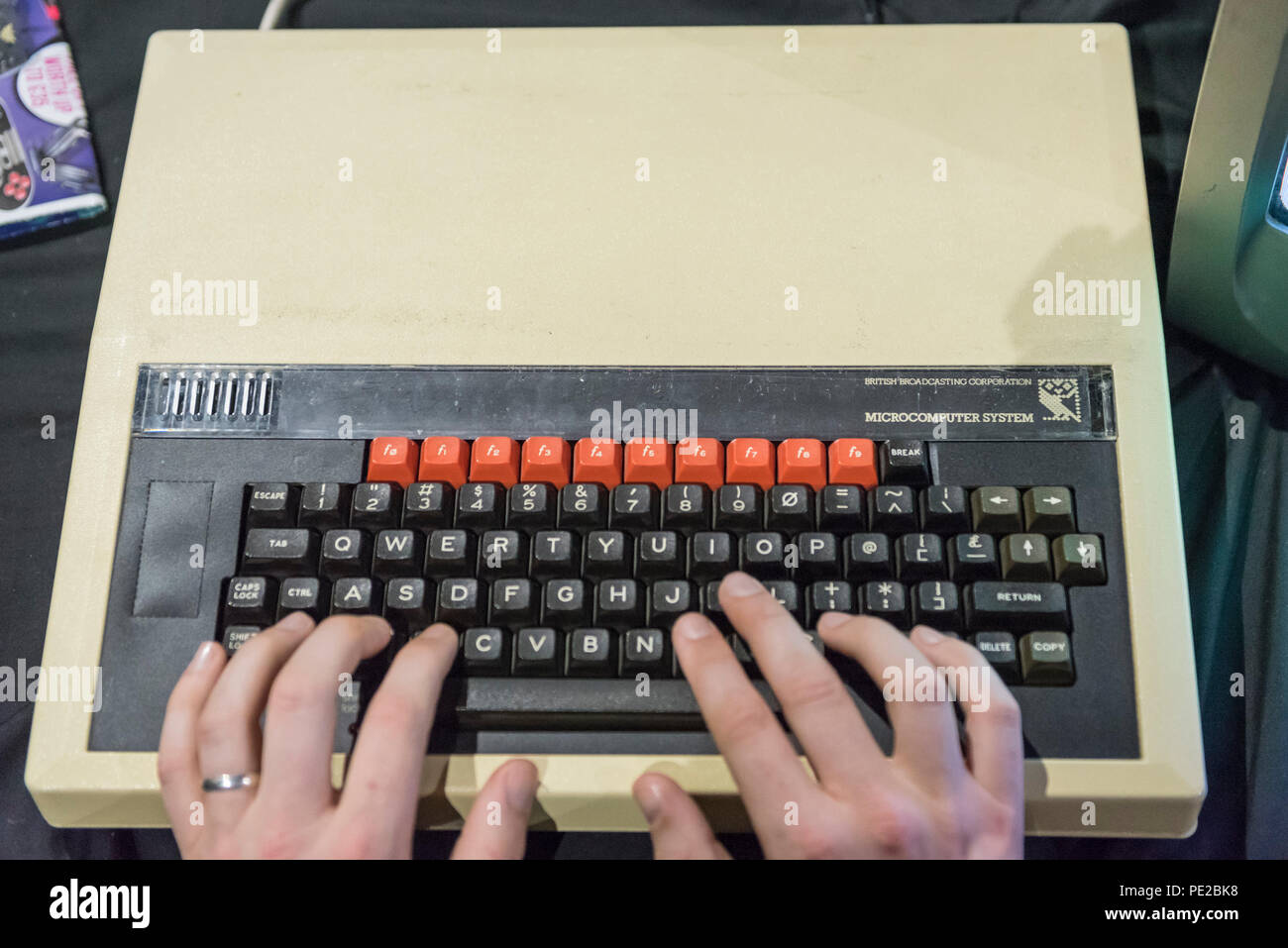 London, UK.  12 August 2018. A visitor plays on the iconic BBC Microcomputer at retro games festival PLAY Expo held in London for the first time at Printworks, Canada Water. Game enthusiasts visited to rediscover the classics, from Donkey Kong, Pong, Super Mario Bros. and Space Invaders to vintage pinball machines, VR, indie games and a dedicated Minecraft zone. The show also included a sneak preview of new retro gaming streaming service, Antstream.  Credit: Stephen Chung / Alamy Live News Stock Photo