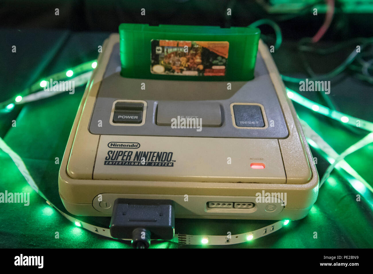 London, UK. 12 August 2018. A Super Nintendo Entertainment System console  at retro games festival PLAY Expo held in London for the first time at  Printworks, Canada Water. Game enthusiasts visited to